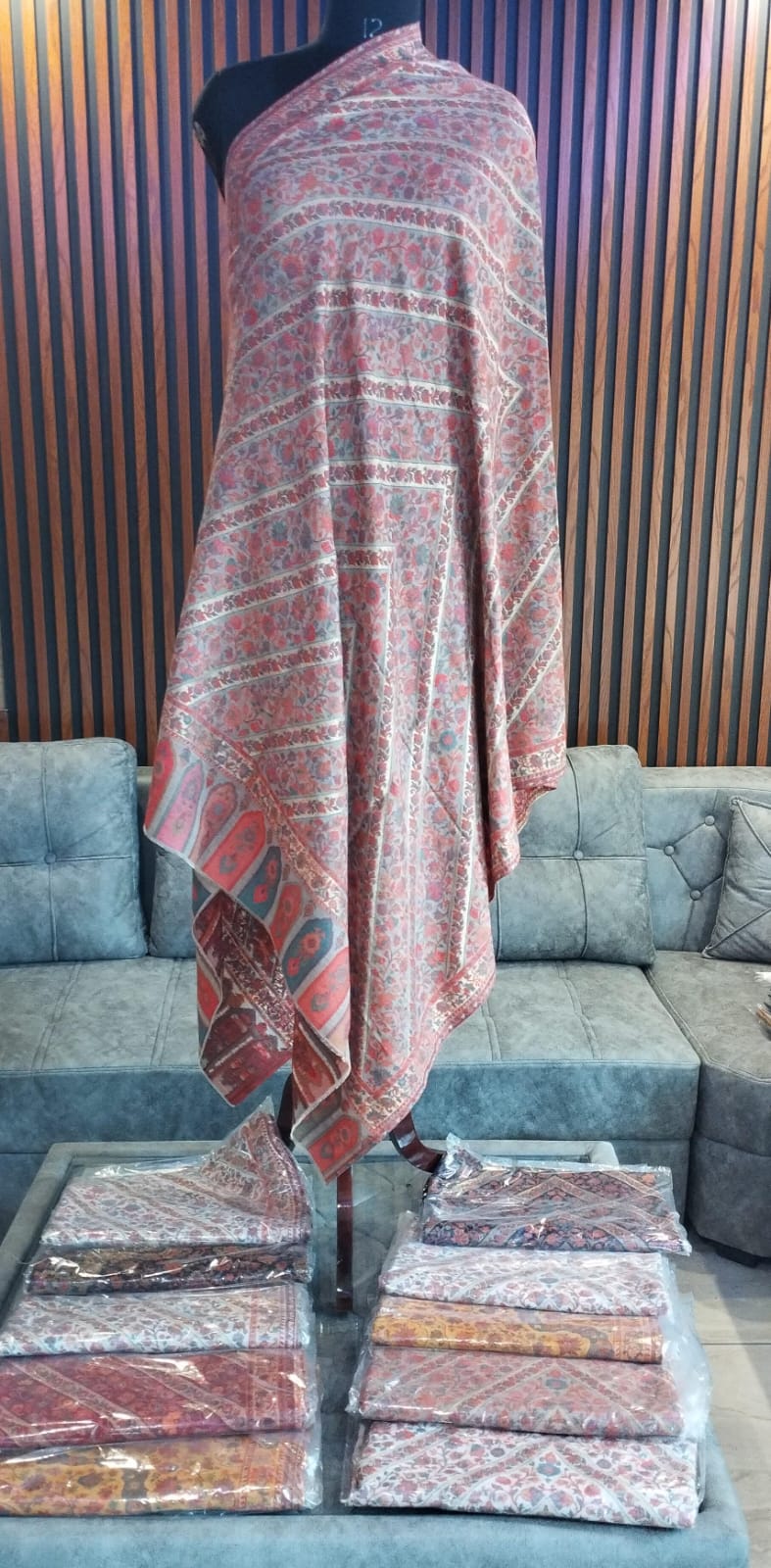 Rumman Kashmiri semi pashmina shawl draped on a mannequin, coral red florals