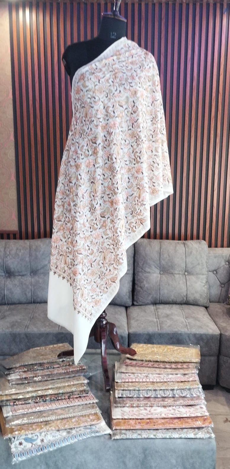 Sumbul Kashmiri semi pashmina shawl draped on a mannequin, ivory with rust vines